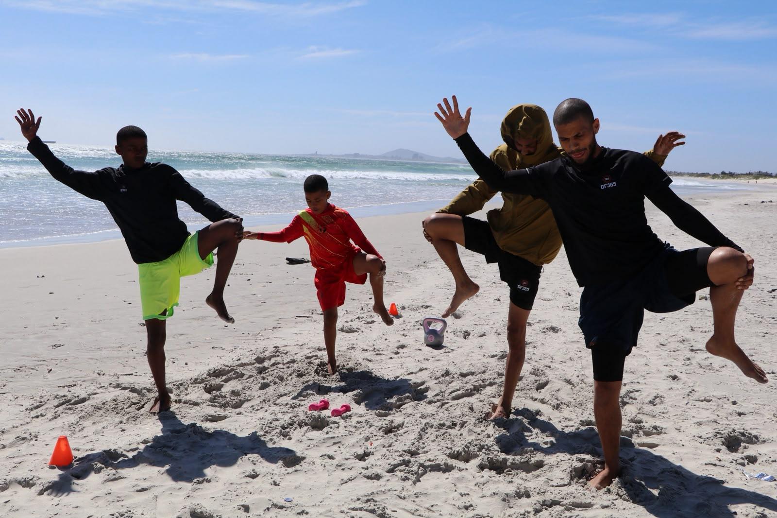 Group doing balance work on the sand
