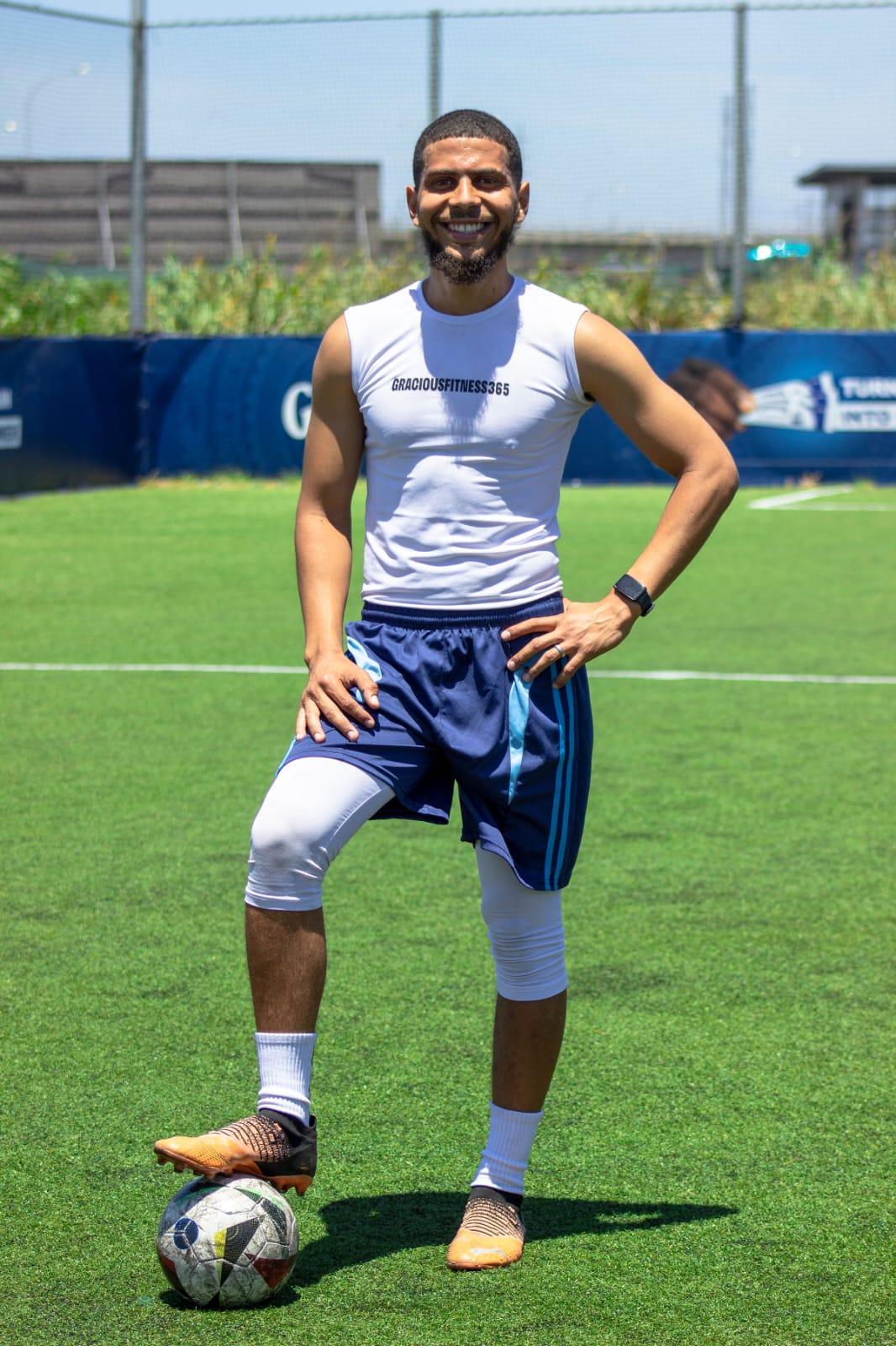 Gracious, founder and coach of Gracious Fitness 365, with a football at his feet